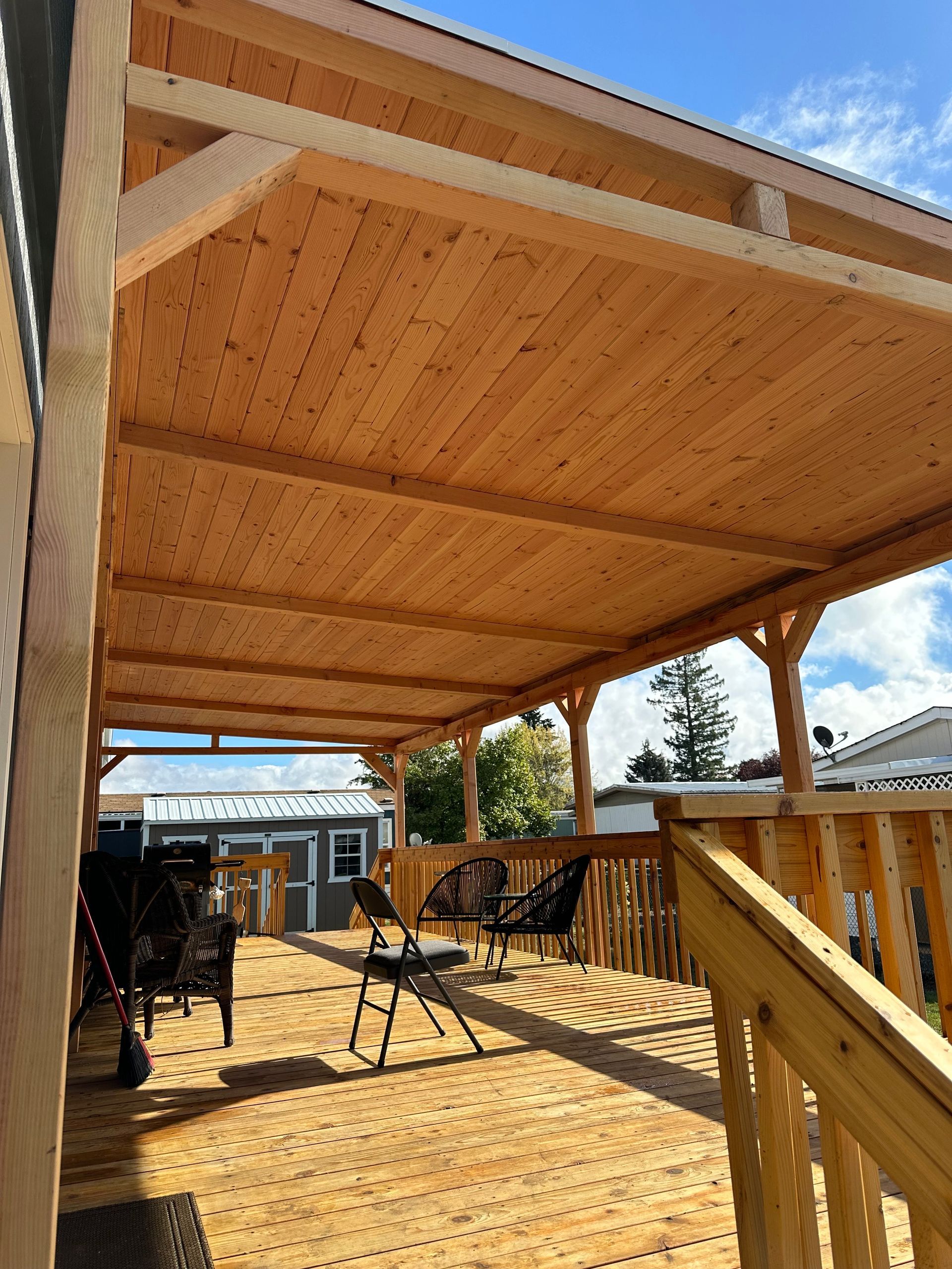 A large porch with a ceiling fan and a skylight