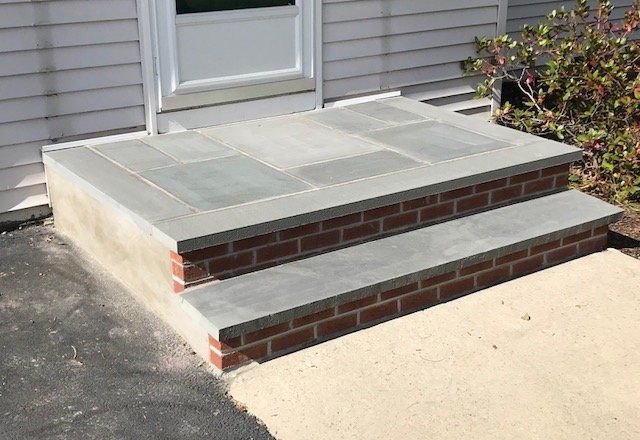 A Brick Porch with Steps Leading up To a Door — Flemington, NJ — LaFerla Bros Inc.
