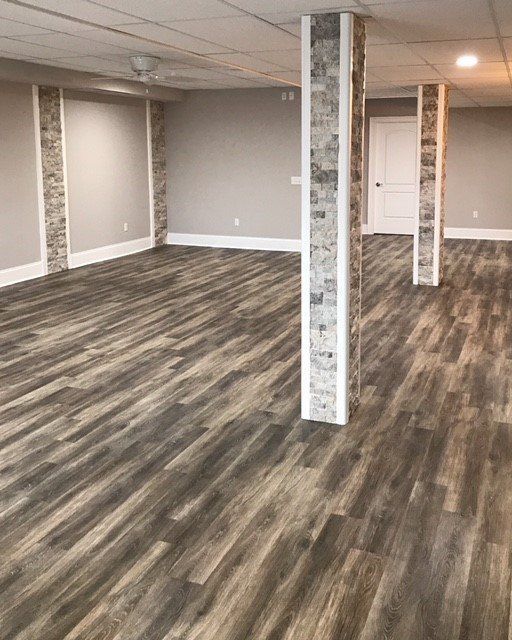 A Large Empty Room with Wooden Floors and Columns — Flemington, NJ — LaFerla Bros Inc.