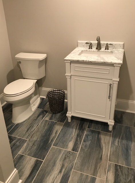 A Bathroom with A Toilet , Sink , and Trash Can — Flemington, NJ — LaFerla Bros Inc.