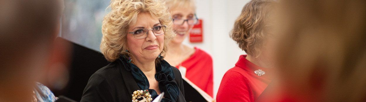 A group of women are standing next to each other in a room.