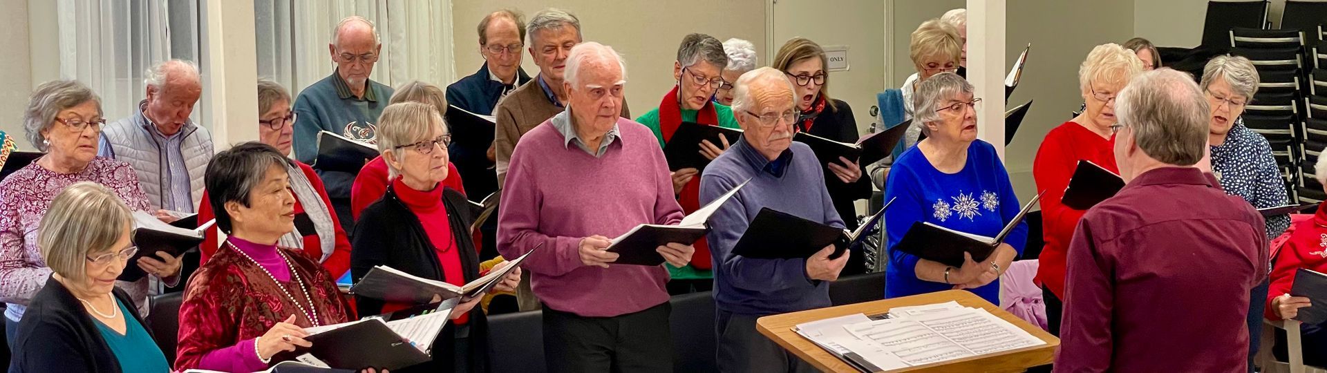 A large group of people are singing in a choir.