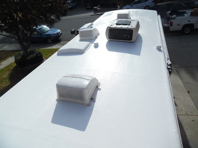 A white roof with a clock on top of it