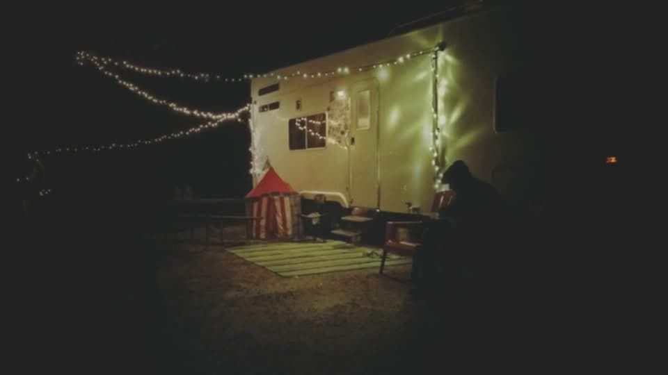 A dark room with christmas lights hanging from the ceiling.