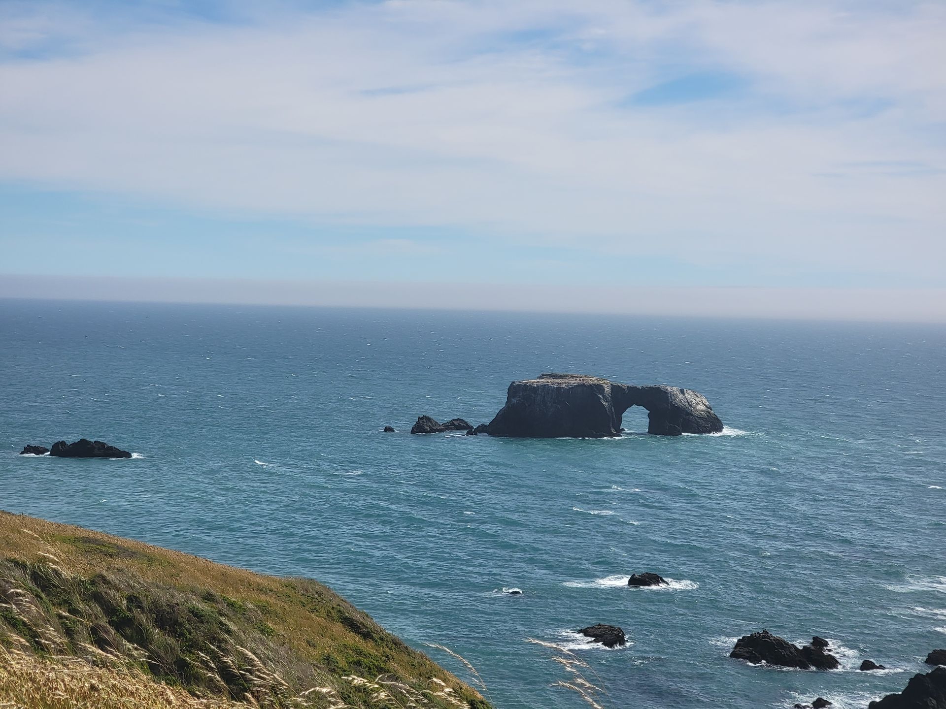 A large rock formation in the middle of the ocean
