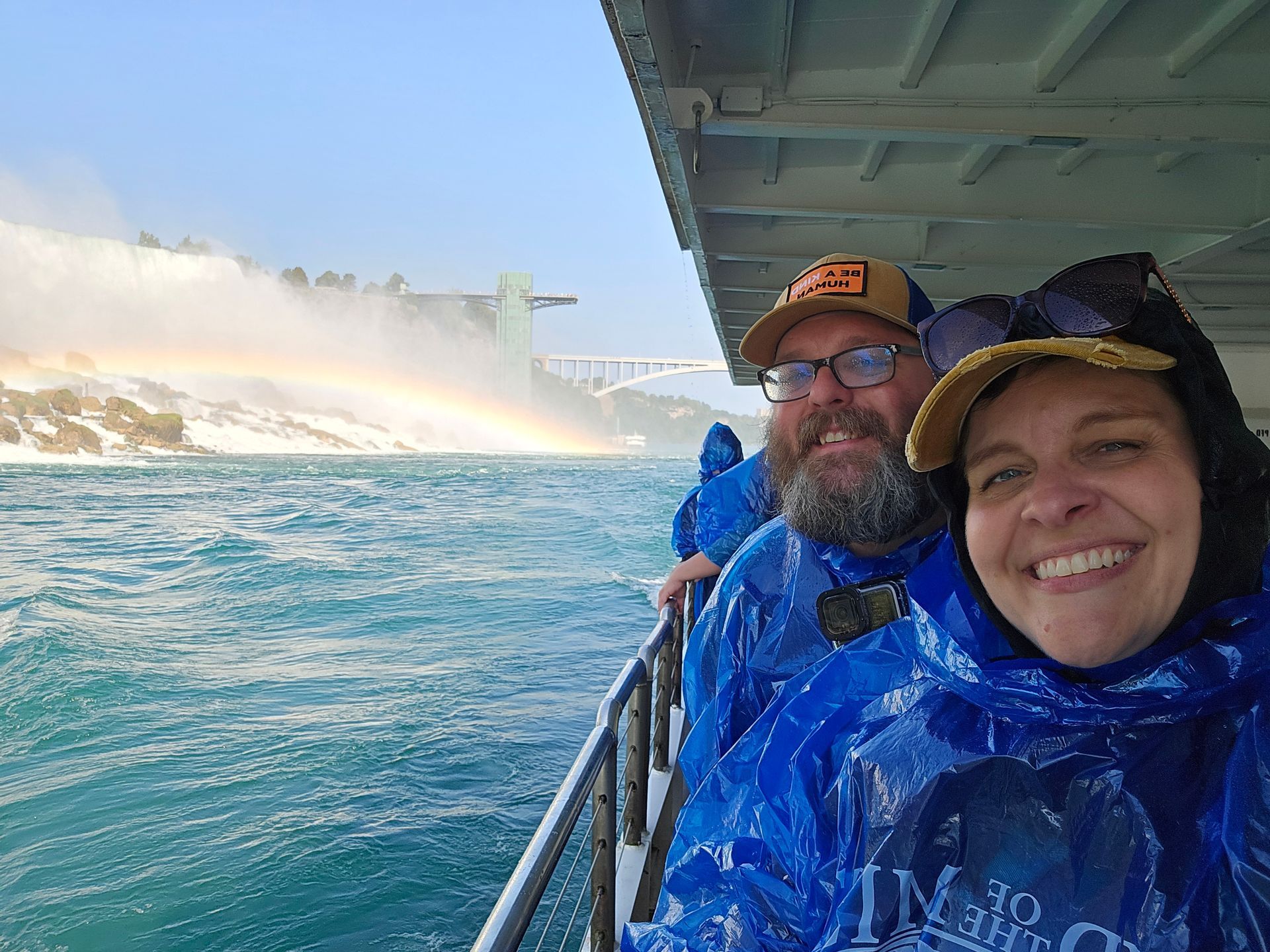 A man and a woman are standing on a boat in the water.