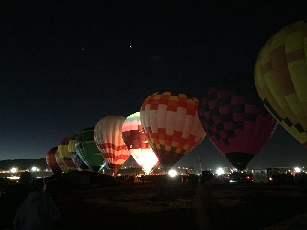 Pre-dawn picture showing hot air balloons in a line being inflated