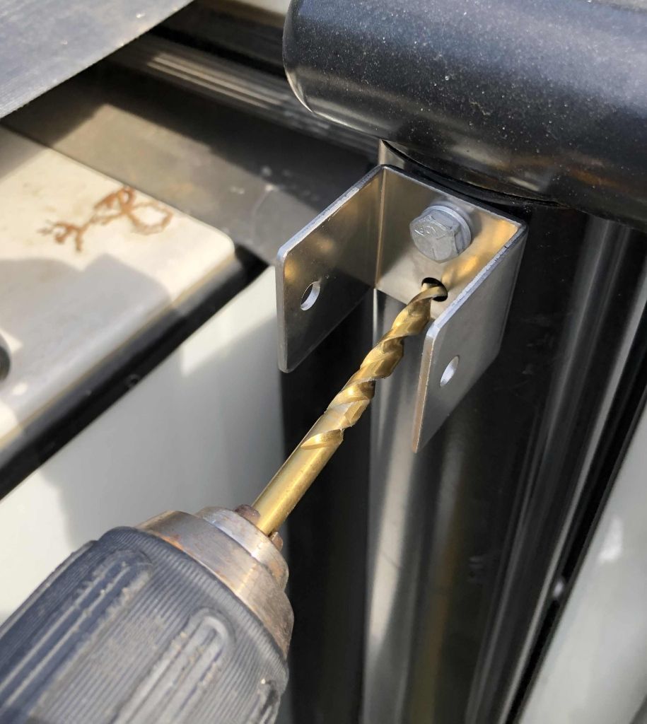 Drilling an RV awning arm through a U bracket