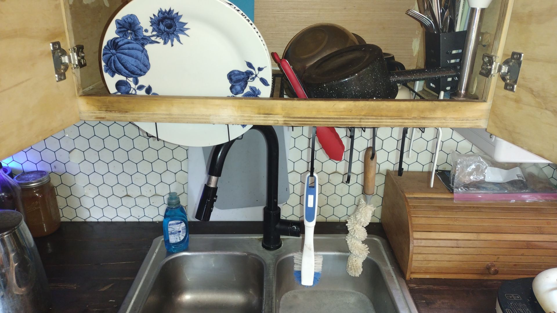 A kitchen sink with a blue and white plate on top
