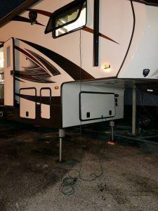 Camper with extension cord from inverter (in front hatch) into bedroom window