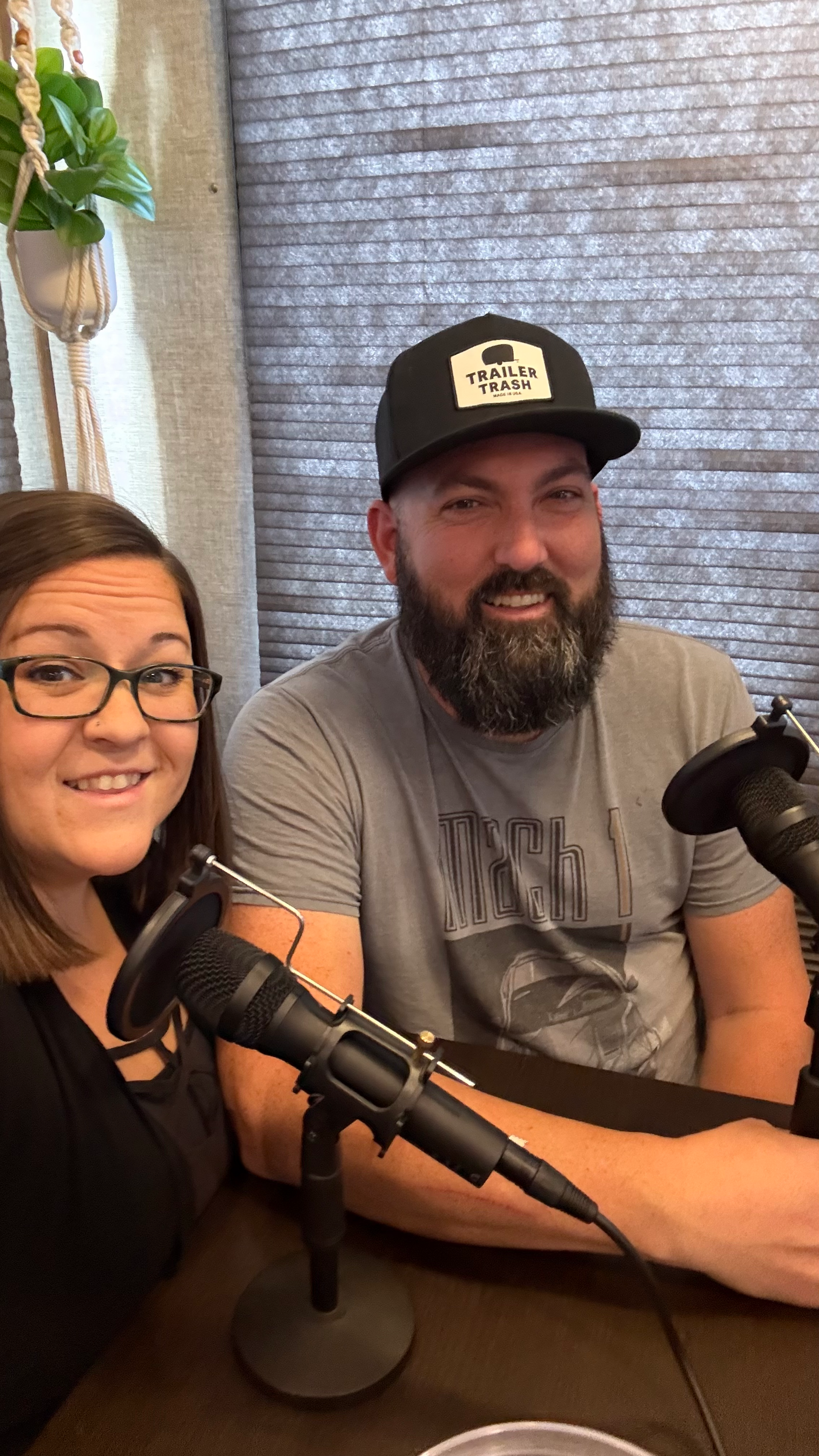 Woman in sunglasses smiles in front of colorful Victorian houses on a sunny day.