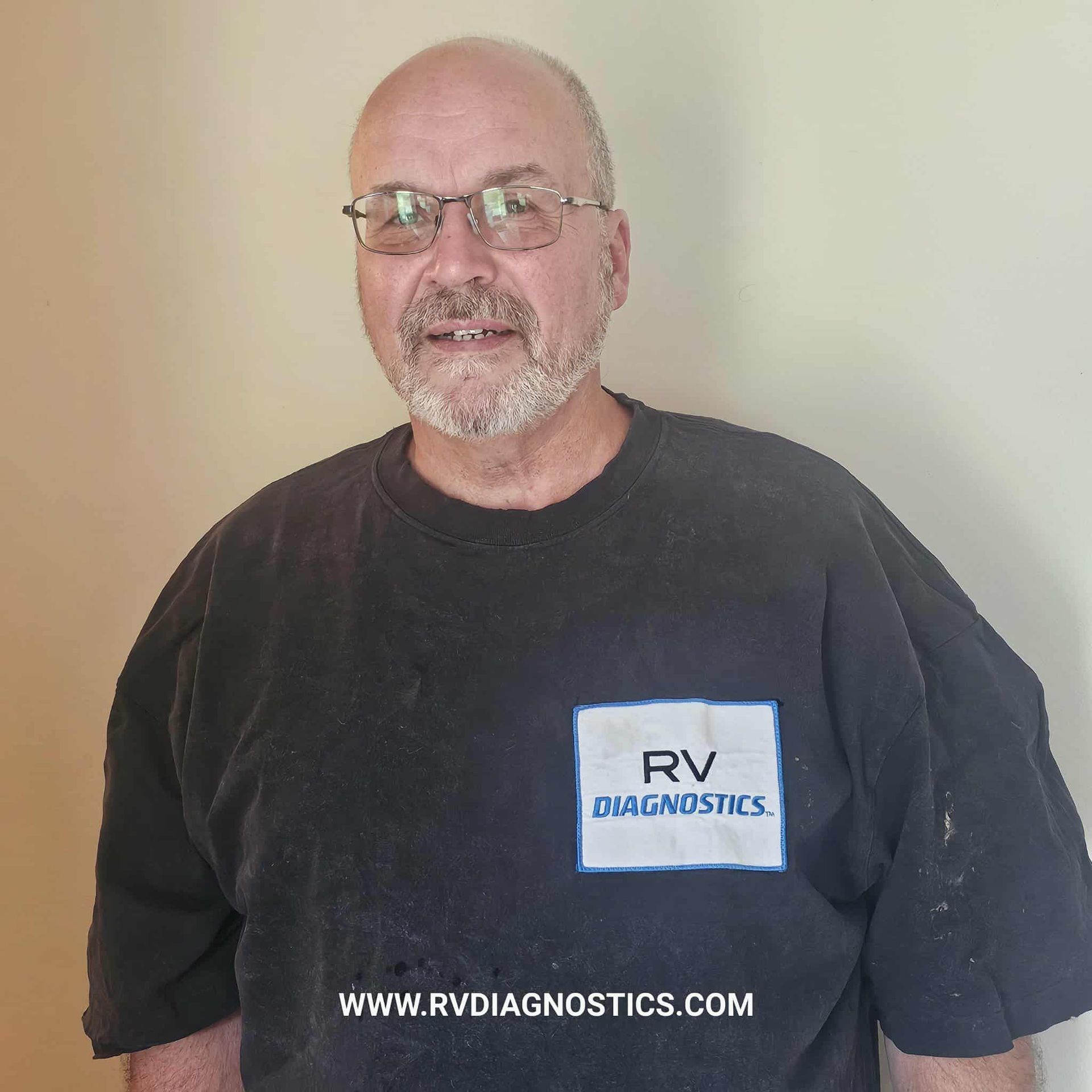 A man wearing a black rv diagnostics shirt