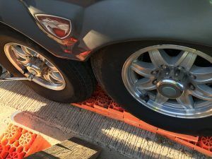 A close up of a car wheel on a ramp.