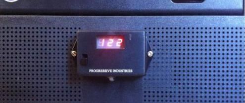 A black box with a digital display that says 122 on it