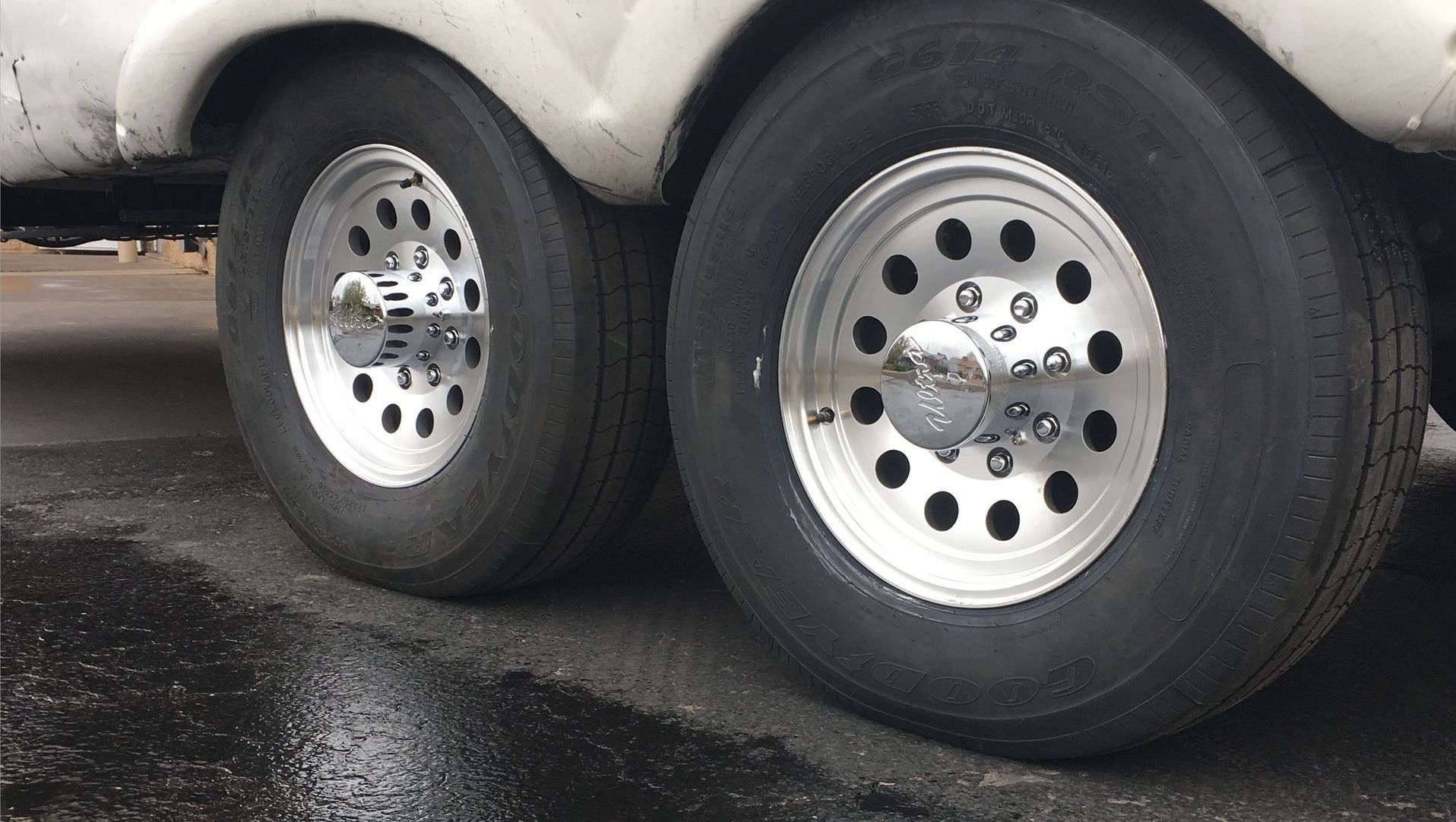 A close up of a trailer 's wheels and tires