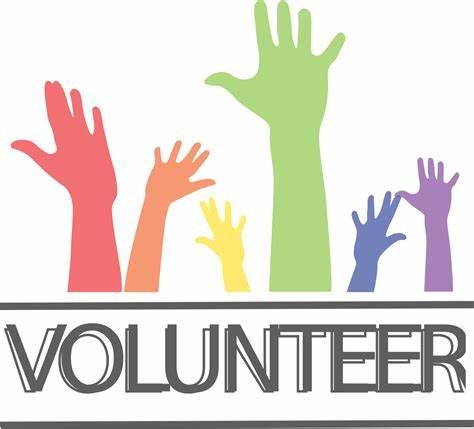 A group of volunteer hands reaching up in the air.