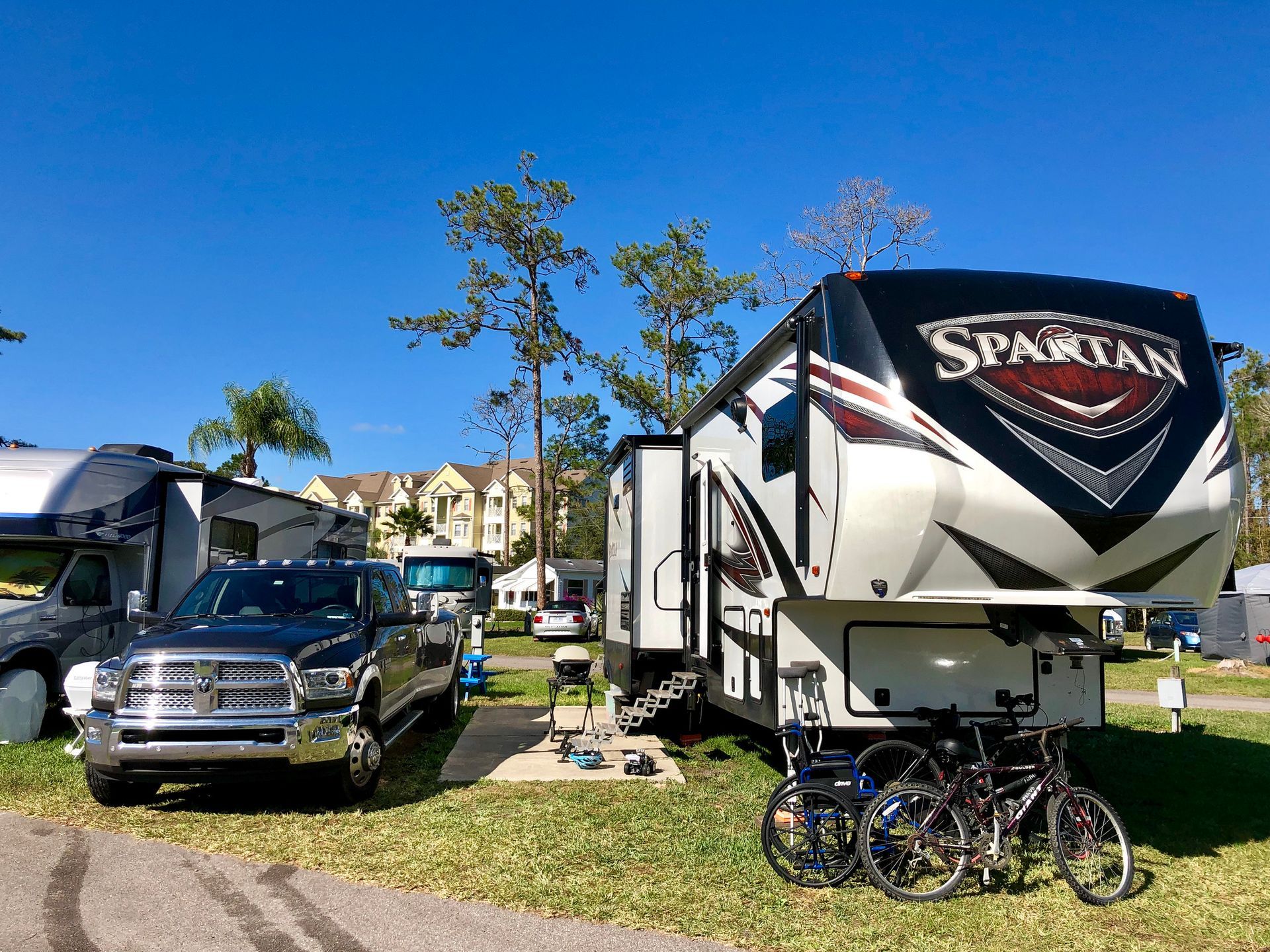 A truck is parked in front of a spartan trailer.