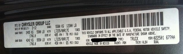 A close up of a sticker on a car that says chrysler group llc