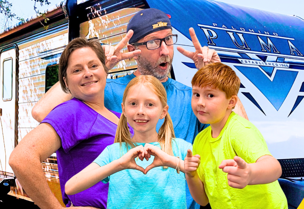 Family stands in front of their RV smiling
