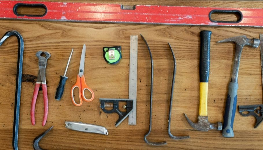 Collection of essential RV tools including wrench set, screwdrivers, tire pressure gauge, and multim