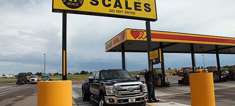 A truck is being weighed at a scales gas station