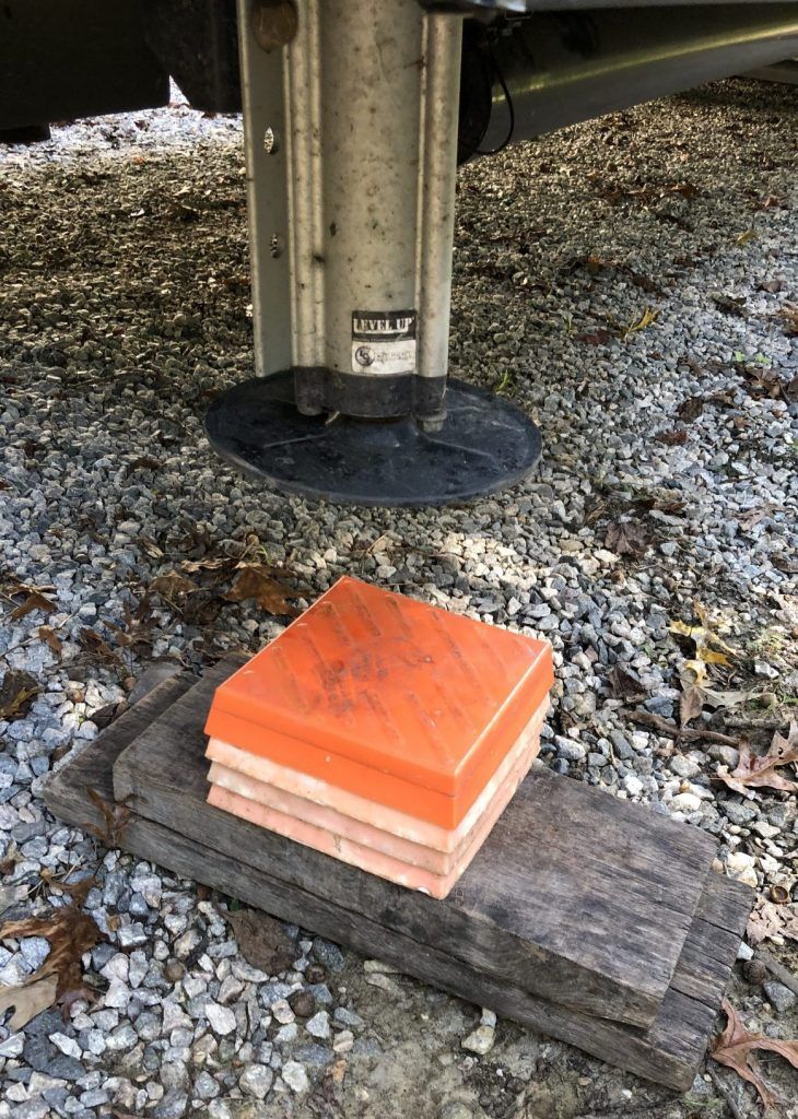 A stack of orange blocks sitting on top of a wooden block.