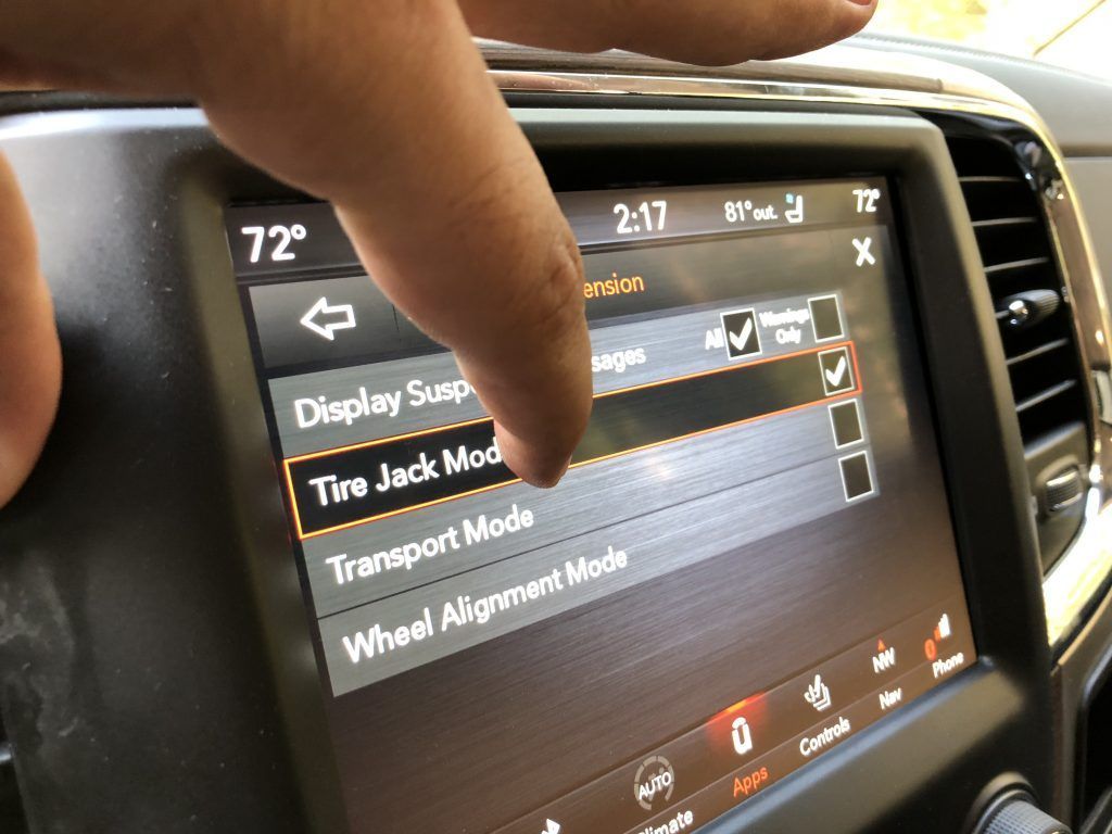 A person is pressing a button on a car dashboard.