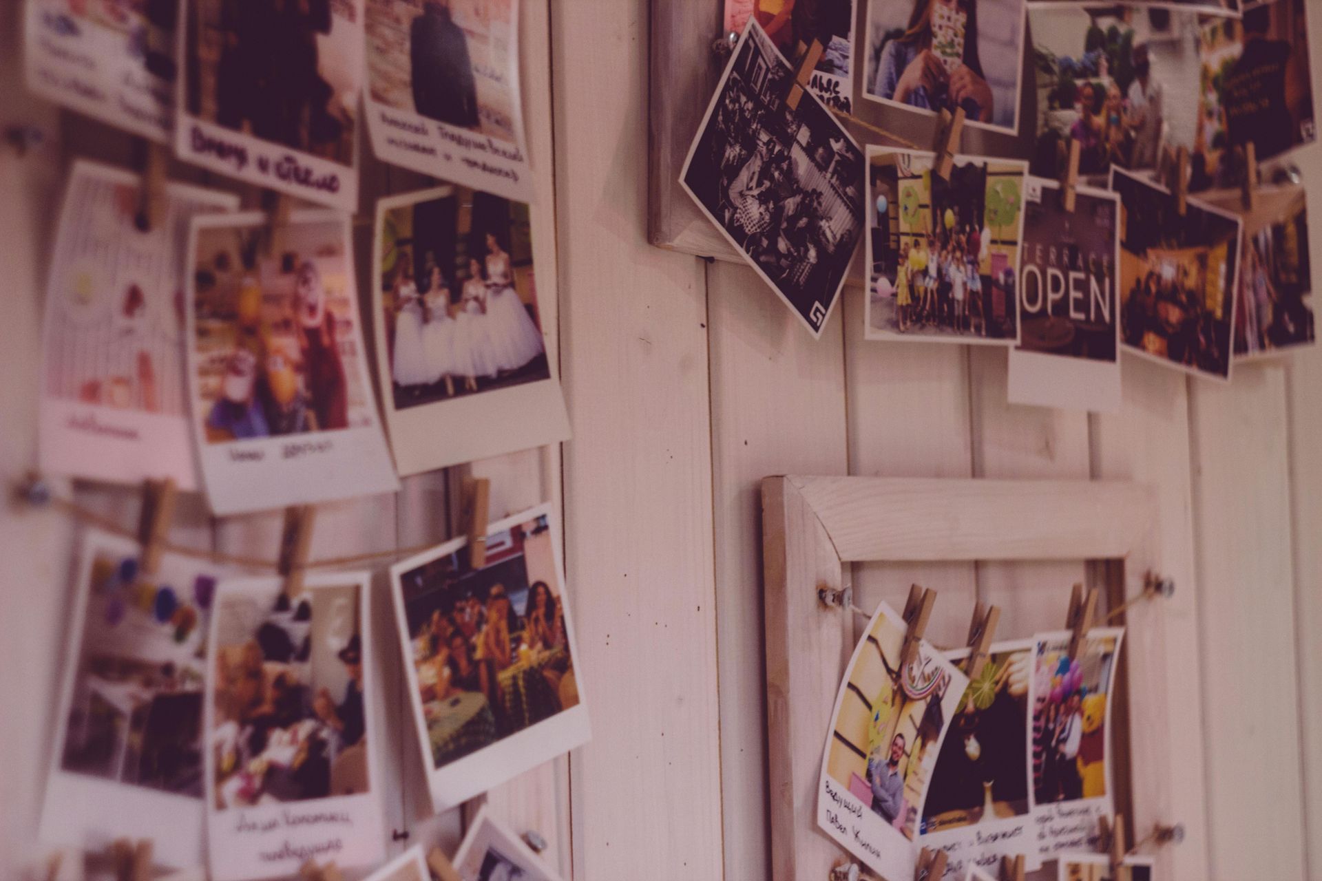 A bunch of pictures are hanging on a wall.