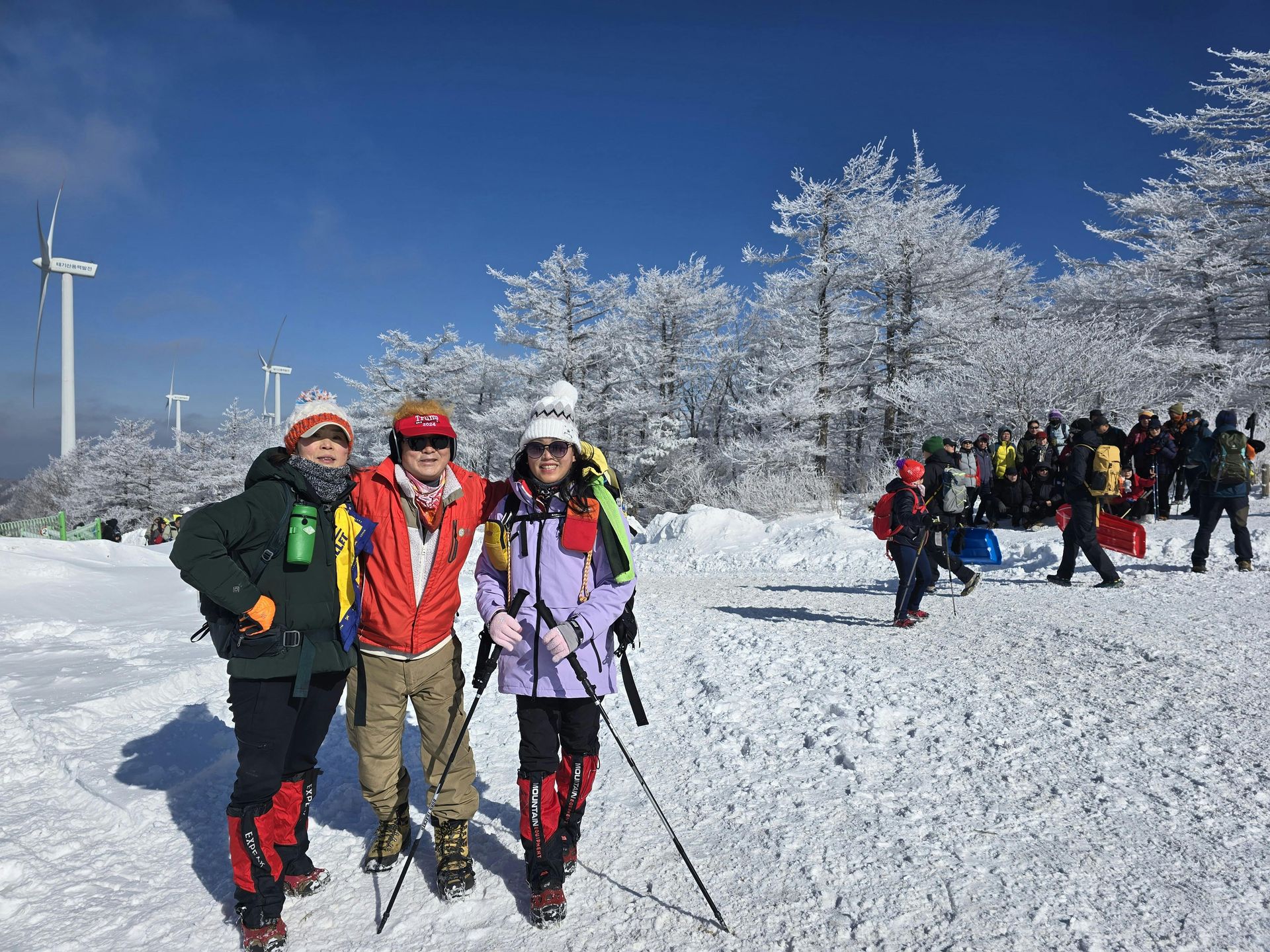 A group of people are standing in the snow.