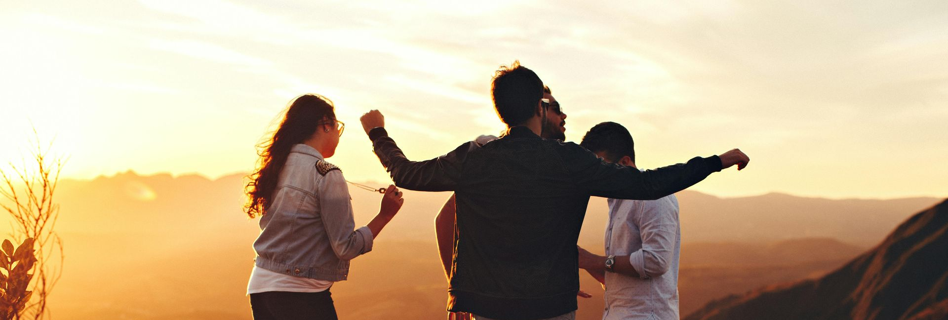 A group of people are standing on a cobblestone street in front of a church.