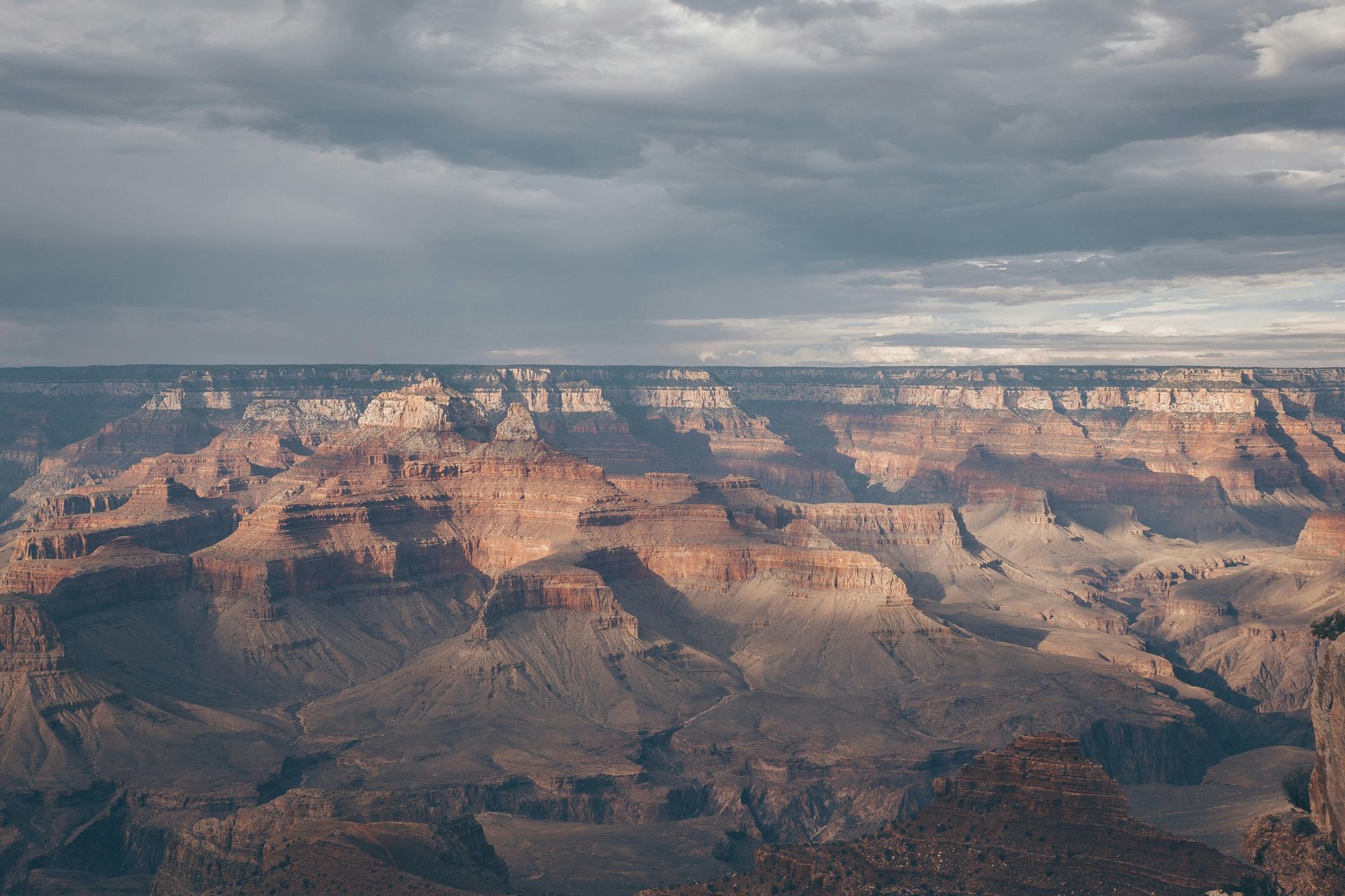 An aerial view of the grand canyon on a cloudy day.
