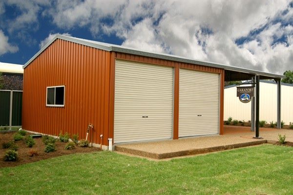 Orange metal storage building with two roll-up doors — More Than Garages Pty Ltd–Ranbuild Tamworth in Taminda, NSW