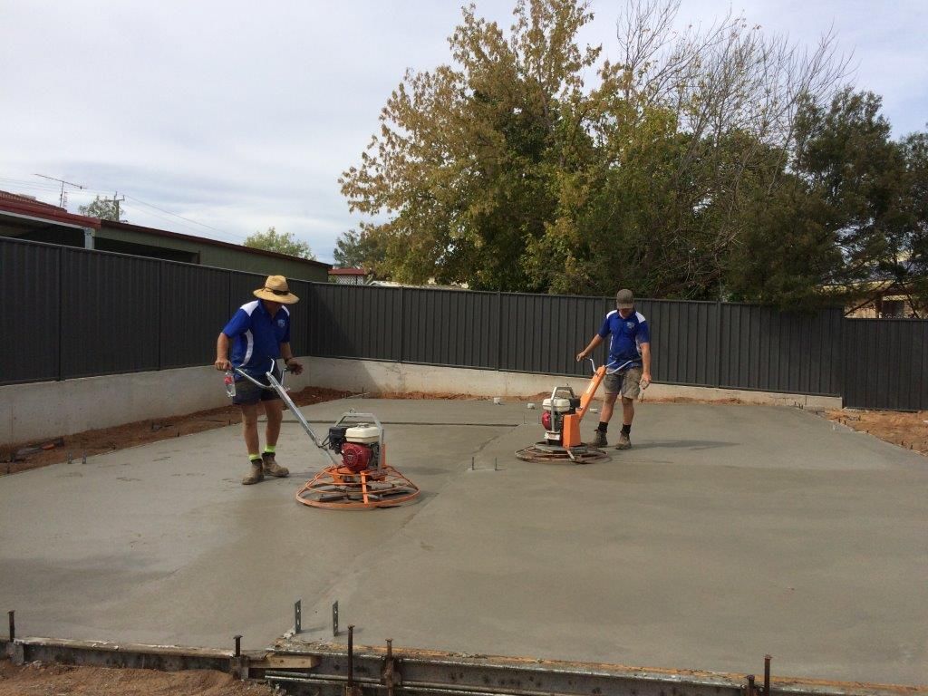 Two workers smoothing wet concrete — More Than Garages Pty Ltd–Ranbuild Tamworth in Taminda, NSW