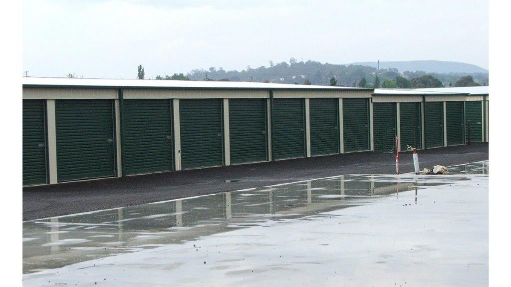 A White Building With A Green Roof And A White Garage Door  — More Than Garages Pty Ltd–Ranbuild Tamworth in Taminda, NSW