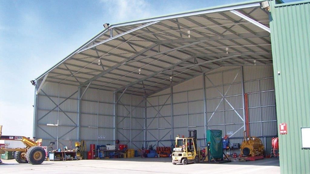 A Large Metal Building With A Blue Sky In The Background  — More Than Garages Pty Ltd–Ranbuild Tamworth in Taminda, NSW