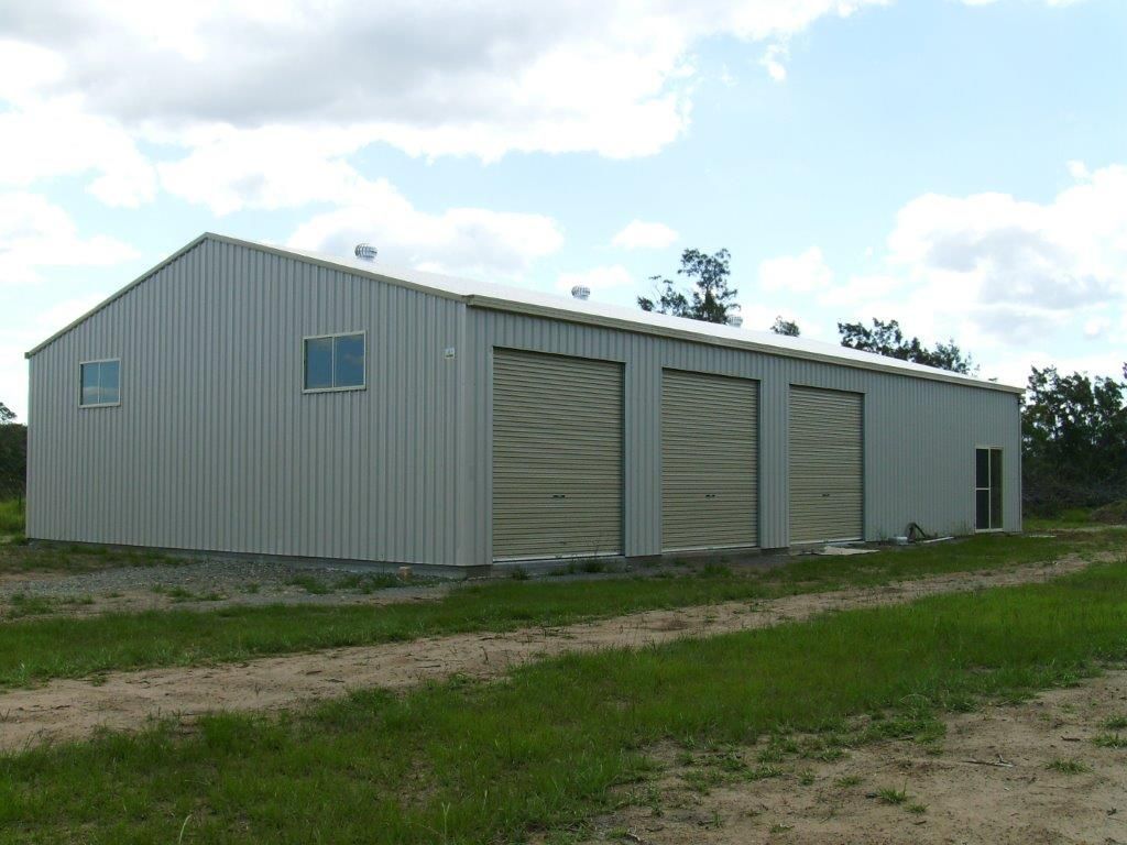 Metal storage building with three roll-up doors — More Than Garages Pty Ltd–Ranbuild Tamworth in Taminda, NSW