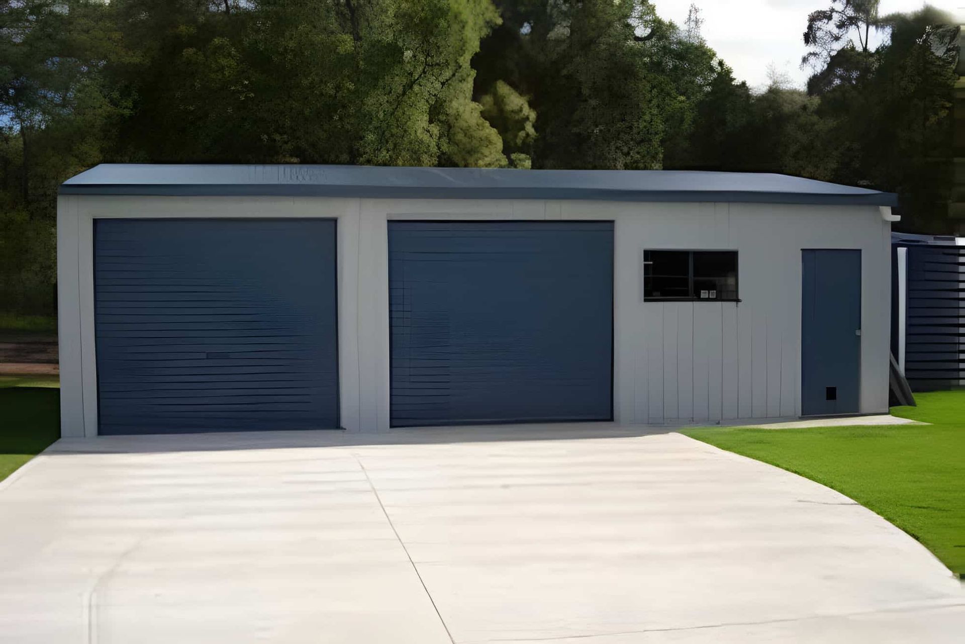 Modern white garage with two blue roll-up doors — More Than Garages Pty Ltd–Ranbuild Tamworth in Taminda, NSW