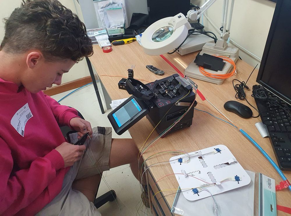 Man Working On An Optic Fibre Fusion Splicing — Electric Services in Tamworth, NSW