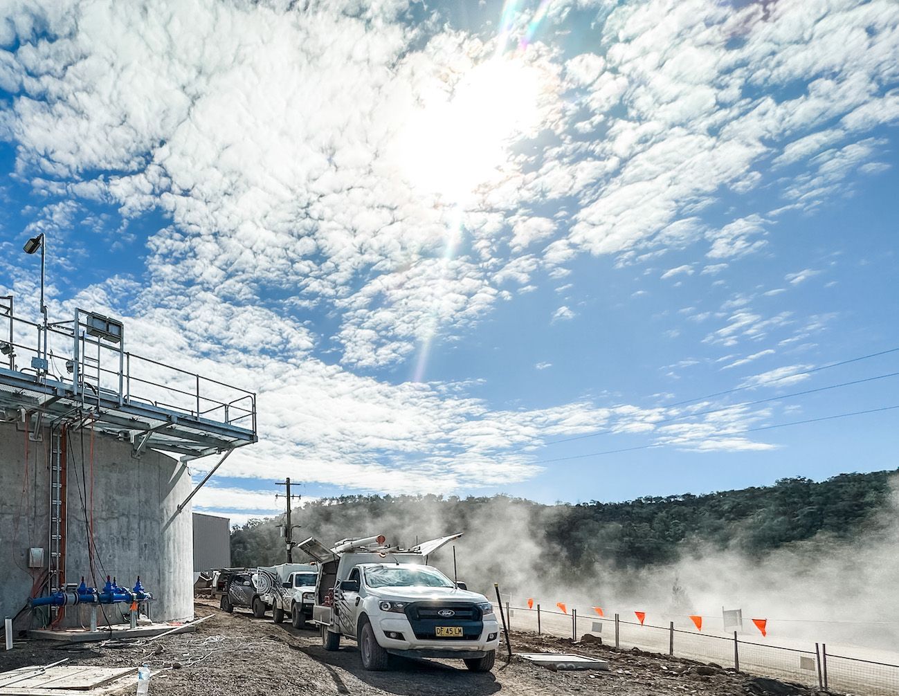 Raw Electrical Services Vehicles Positioned Near a Reservoir Site — Electric Services in Tamworth, NSW