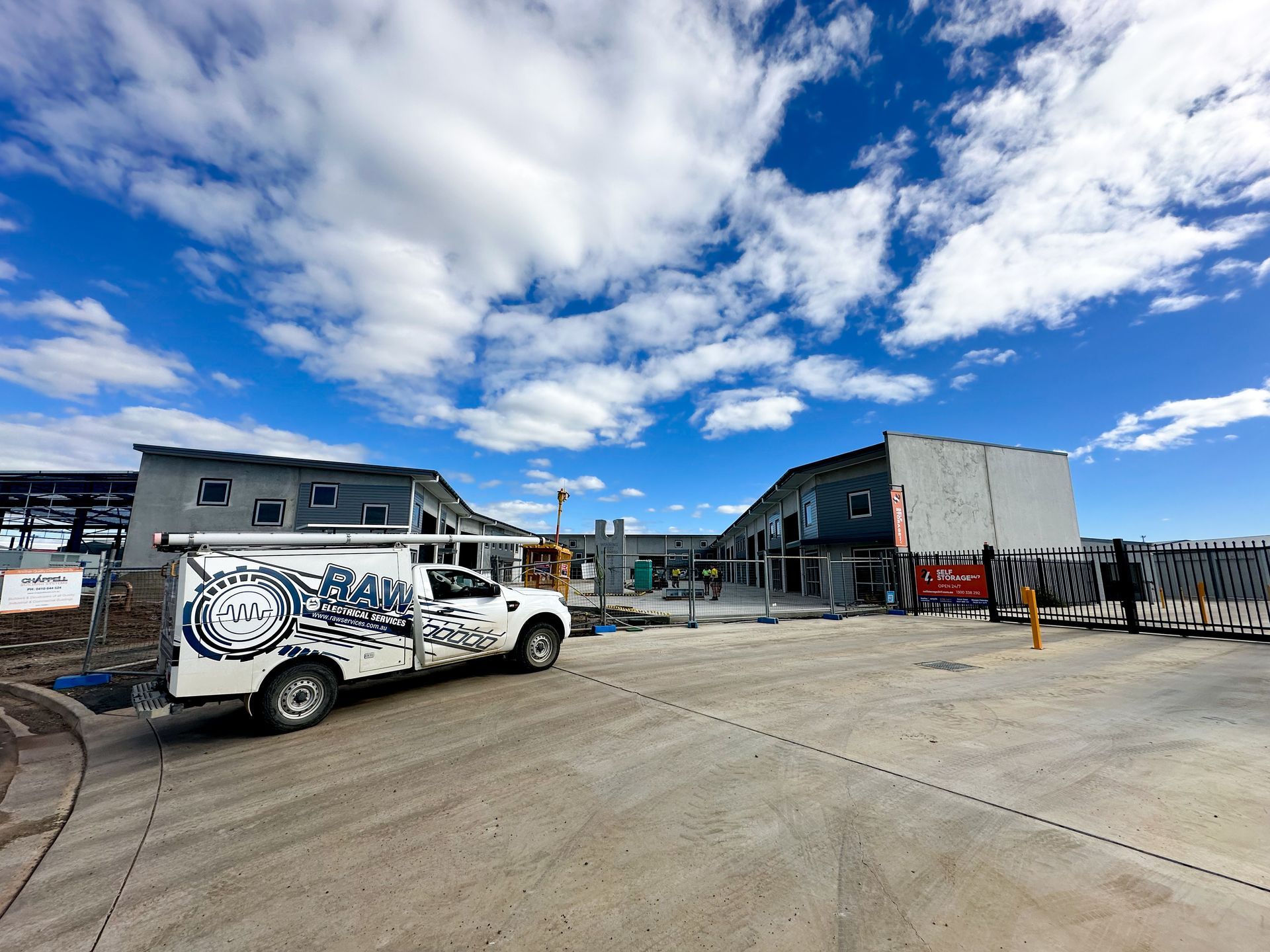 Electrical Van Parked Outside Commercial Building— Electric Services in Tamworth, NSW