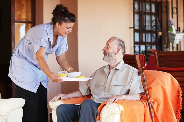 home health aide serving patient meal