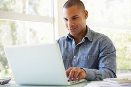 man checking news on laptop