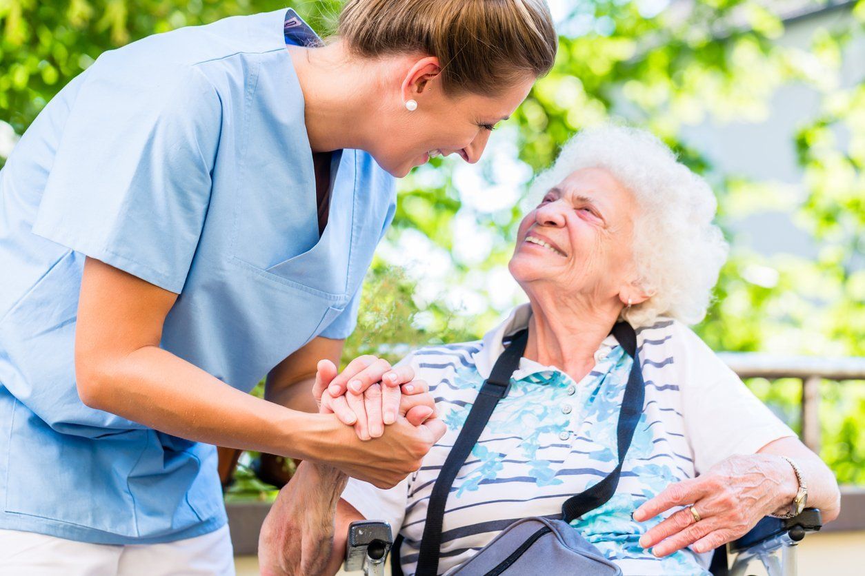 Senior Care Professional Assisting Elderly Client