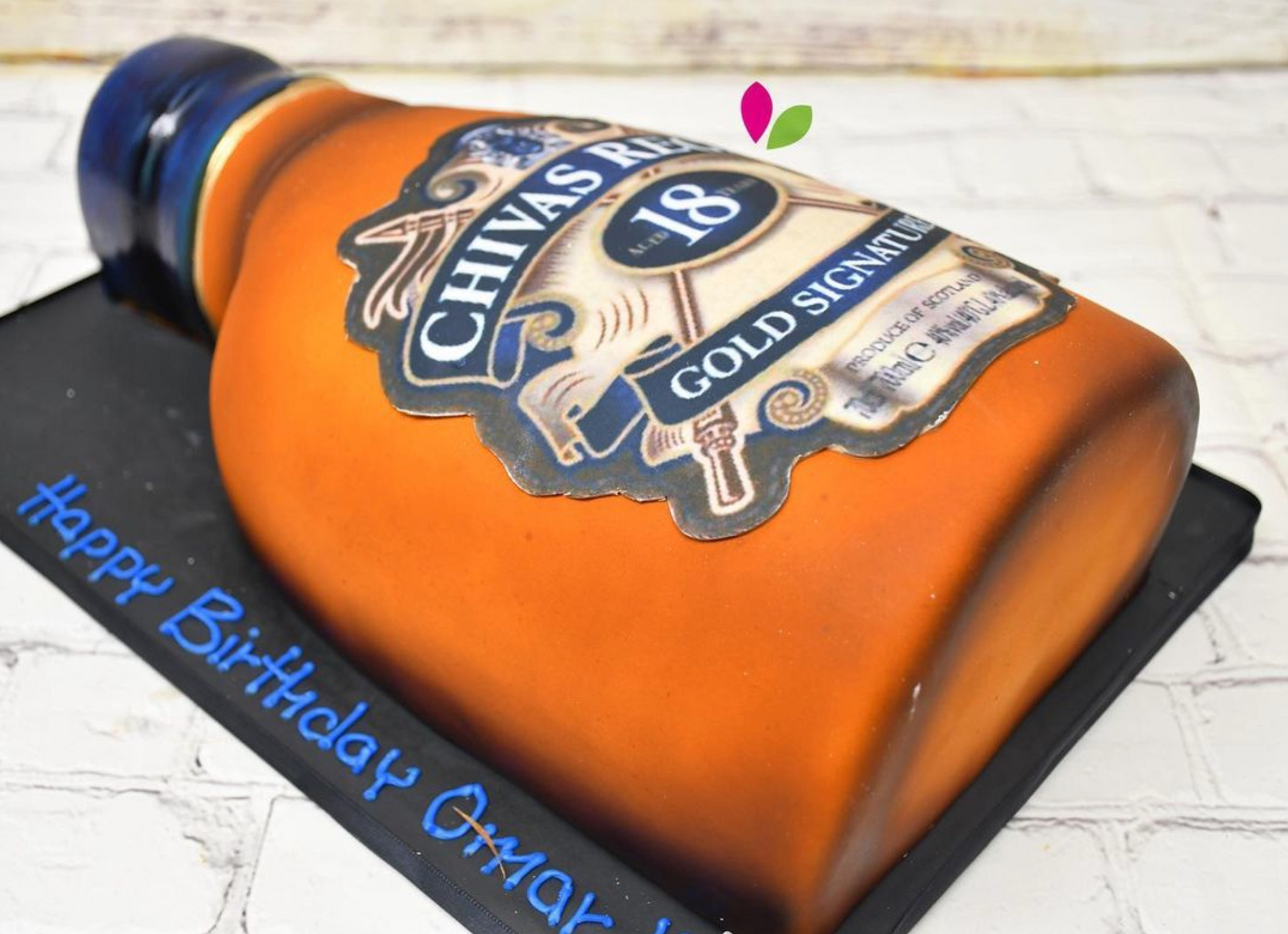 A cake in the shape of a bottle of chivas 18