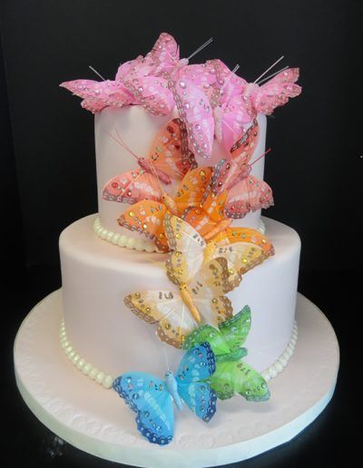 A cake with butterflies and flowers on it