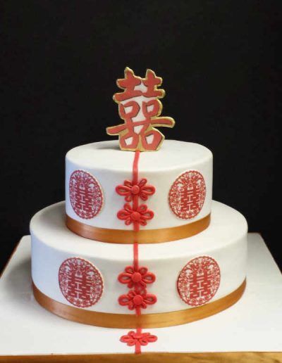 A white and red cake with chinese characters on it
