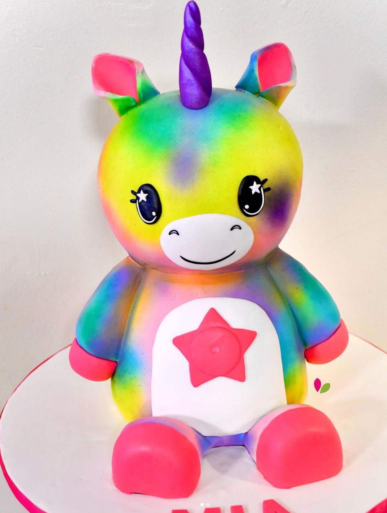 A stuffed unicorn with a pink star on its chest