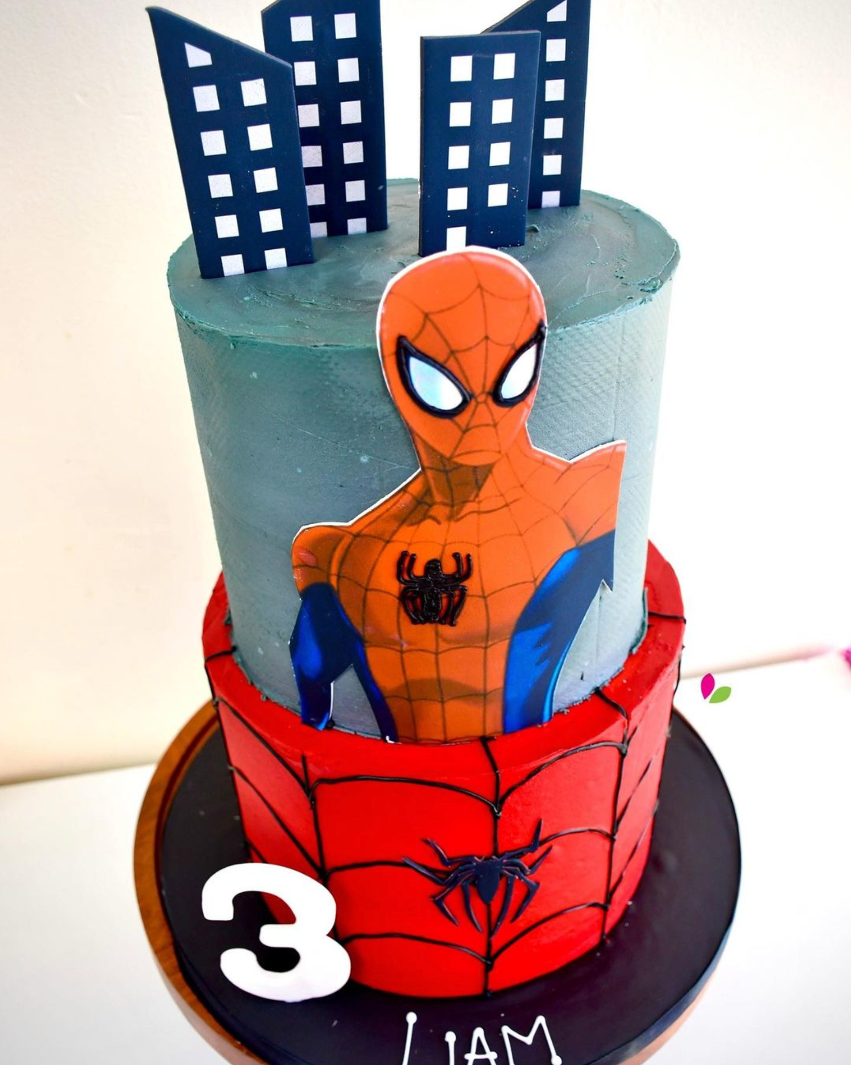 A cake with a picture of spider man on it
