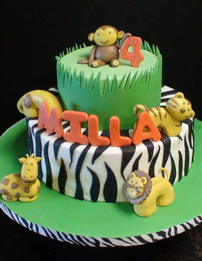 A cake with animals and the name ella on it