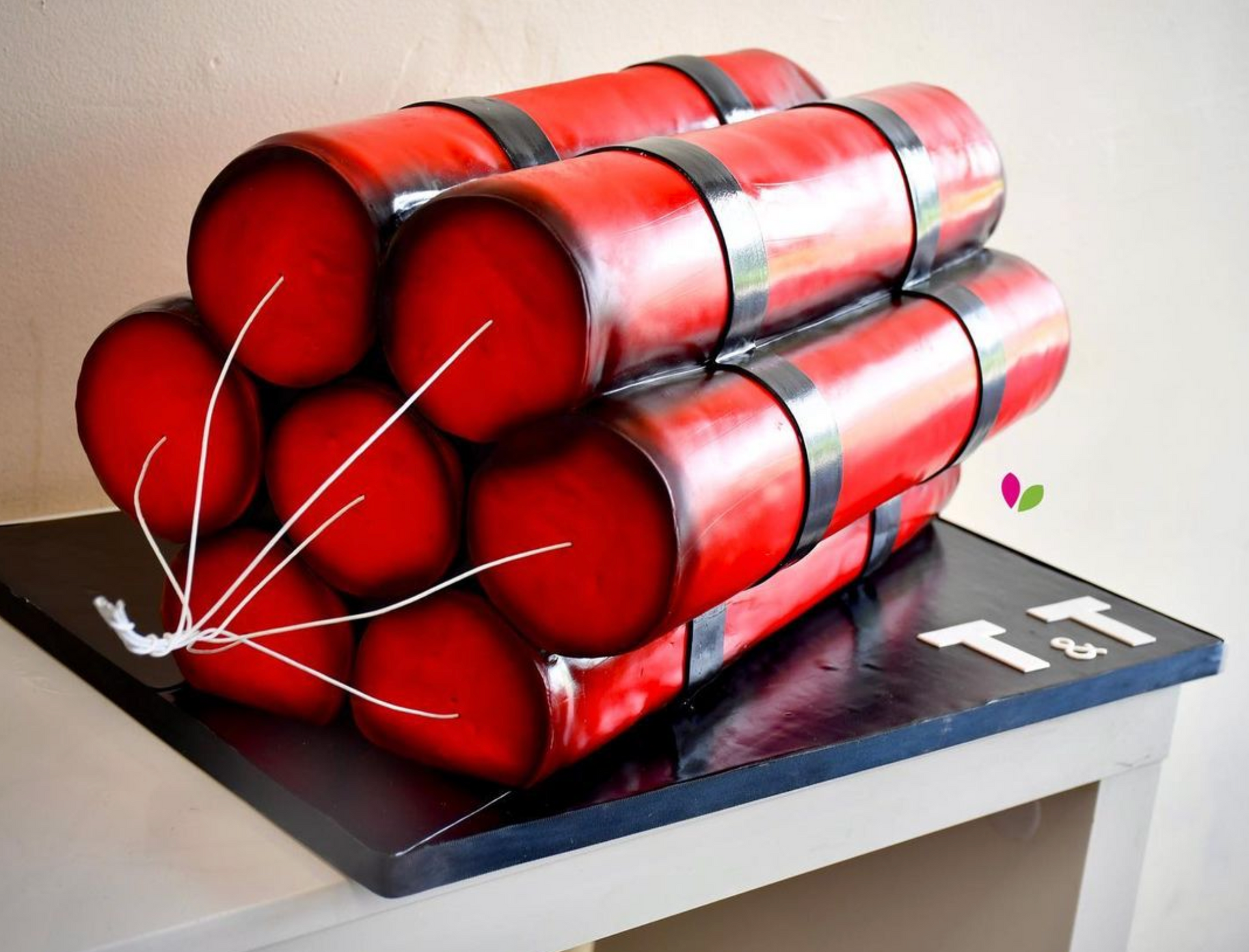 A cake that looks like dynamite is on a table